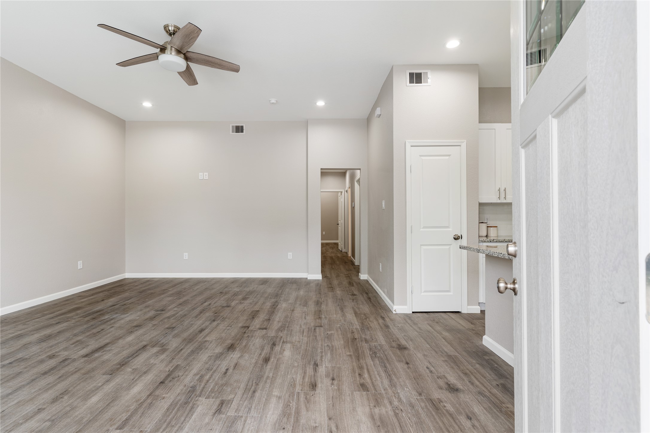 1319 East 35th Street, Unit B Houston, TX 77022 - Photo 4 of 24 a view of a hallway with wooden floor and a ceiling fan