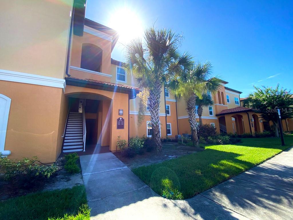 5451 Vineland Road, Unit 2308 Orlando, FL 32811 - Photo 1 of 1 a front view of house and yard with green space
