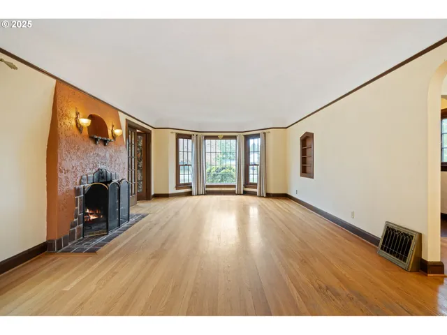 a view of a livingroom with wooden floor and furniture