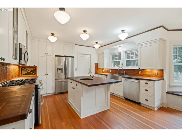 a kitchen with stainless steel appliances granite countertop a stove and a refrigerator