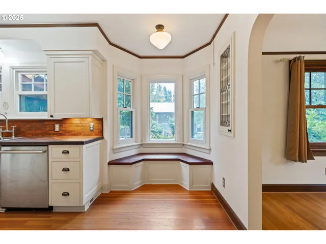 a view of kitchen with granite countertop cabinets and window