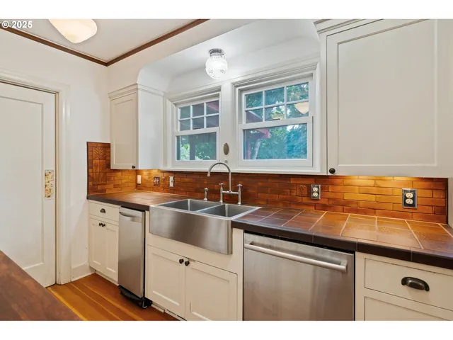 a kitchen with stainless steel appliances granite countertop a sink and a microwave