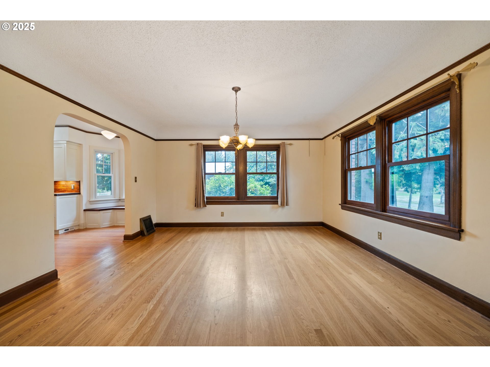 1230 Southeast Barnes Road Gresham, OR 97080 - Photo 17 of 31 a view of an empty room with wooden floor and a window