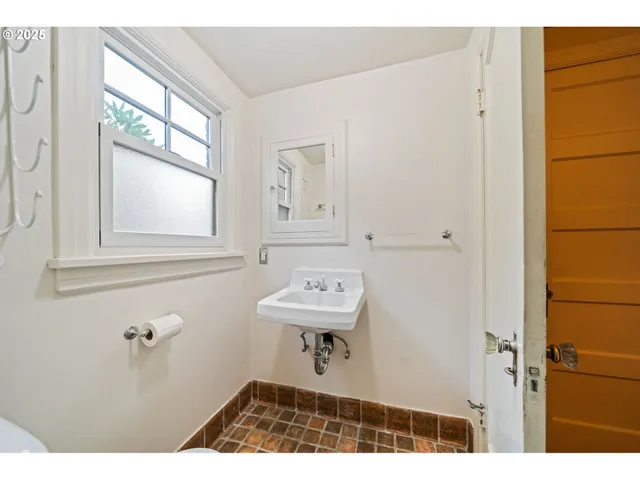a bathroom with a sink a window and a mirror