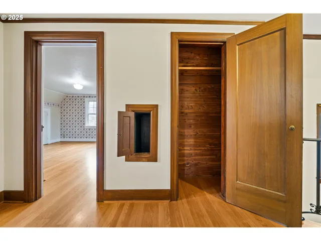 a view of hallway with wooden floor