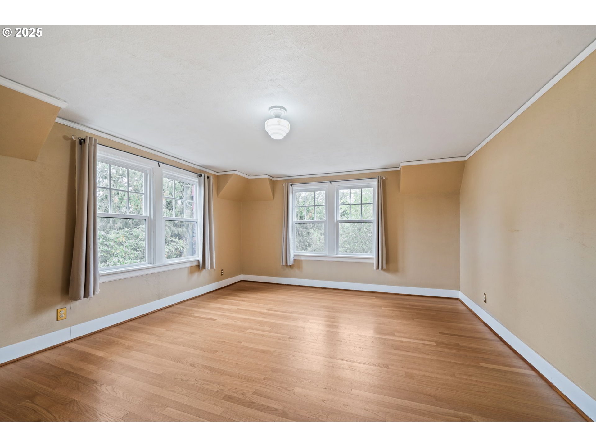 1230 Southeast Barnes Road Gresham, OR 97080 - Photo 25 of 31 a view of an empty room with a window and wooden floor
