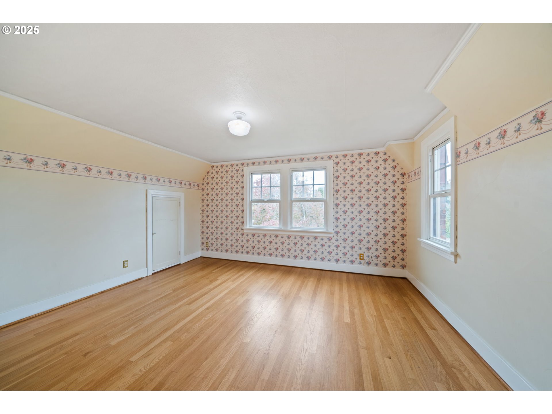 1230 Southeast Barnes Road Gresham, OR 97080 - Photo 26 of 31 a view of an empty room with wooden floor and a window