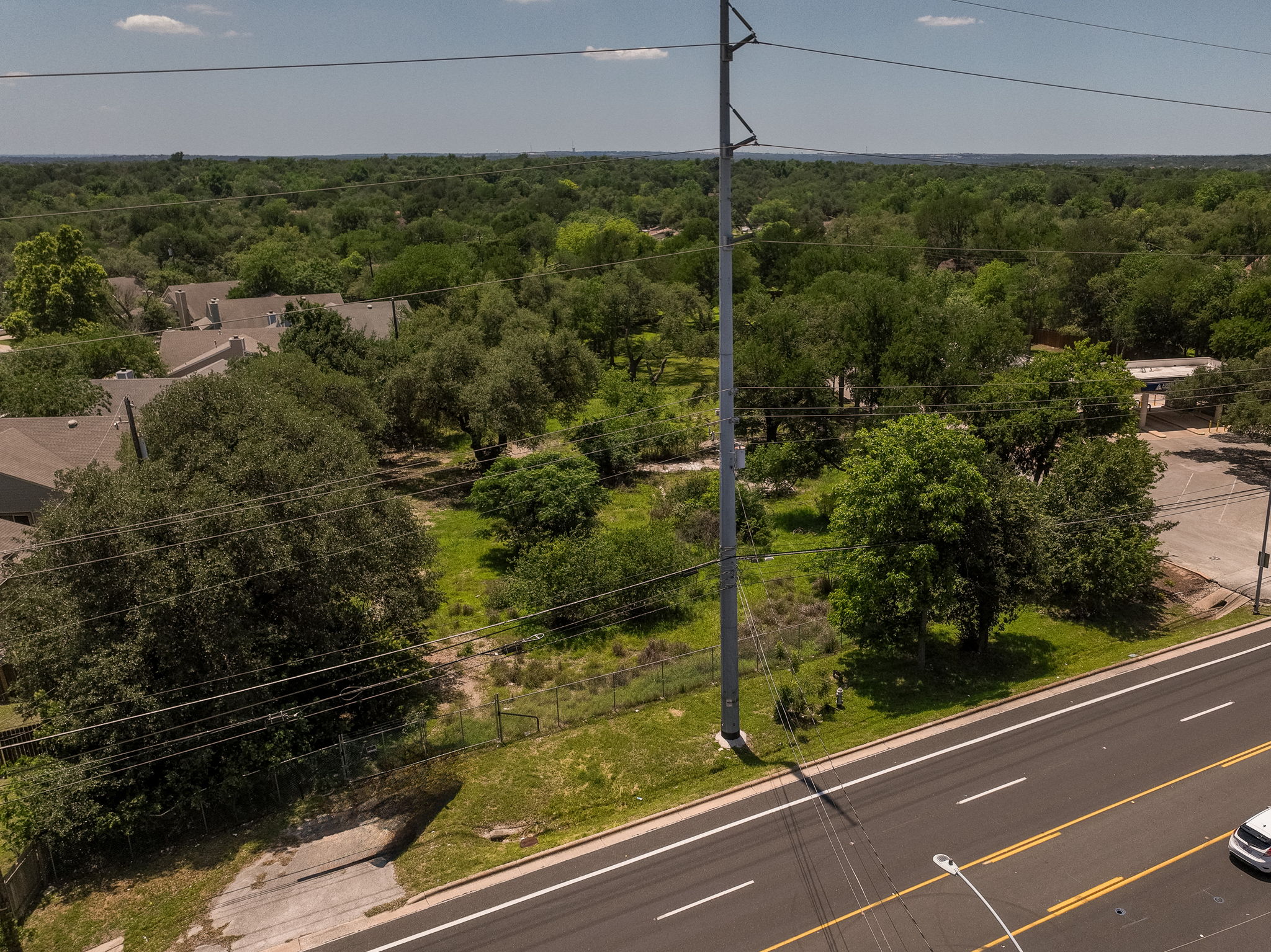 12182 Jollyville Road Austin, TX 78759 - Photo 20 of 25 Expansive undeveloped land parcel featuring mature trees and direct road frontage
