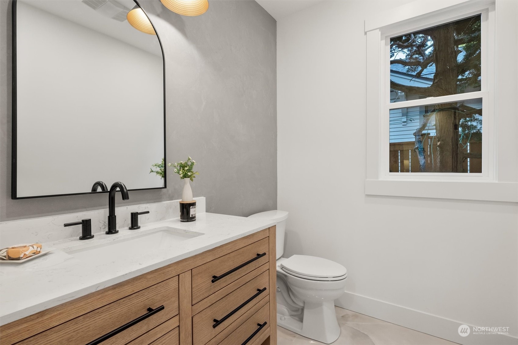 3934 Interlake Avenue North Seattle, WA 98103 - Photo 19 of 40 a bathroom with a toilet a sink and mirror