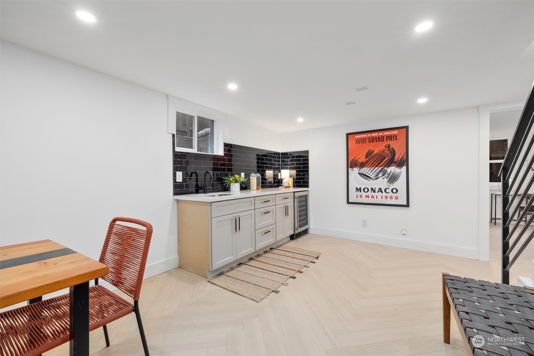 3934 Interlake Avenue North Seattle, WA 98103 - Photo 32 of 40 a white kitchen with stainless steel appliances kitchen island granite countertop a sink and cabinets
