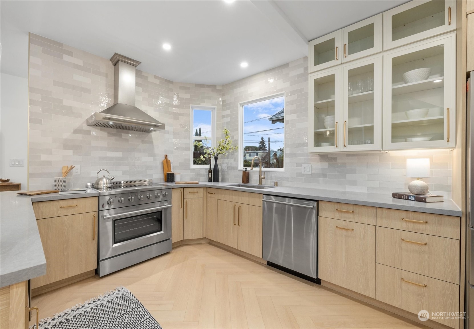 3934 Interlake Avenue North Seattle, WA 98103 - Photo 9 of 40 a kitchen with stainless steel appliances granite countertop a stove and white cabinets