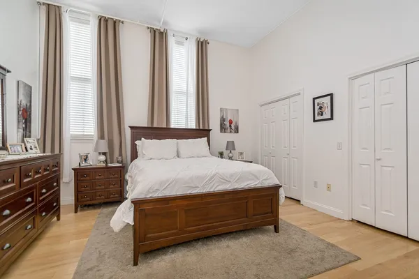 a spacious bedroom with a bed and a window