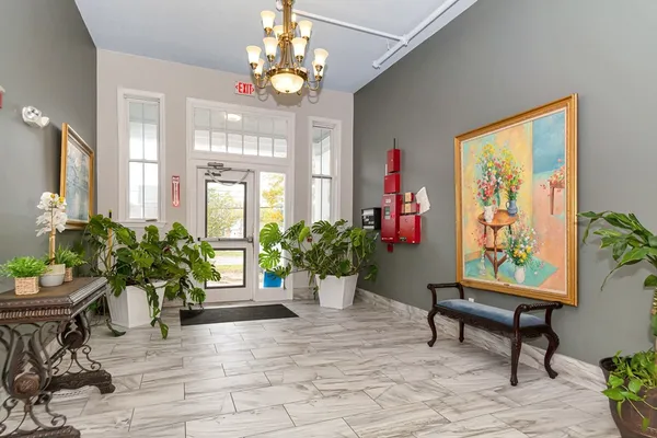 a view of a livingroom with furniture and a window