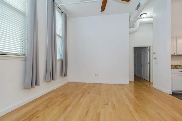 a view of a room with wooden floor and a window