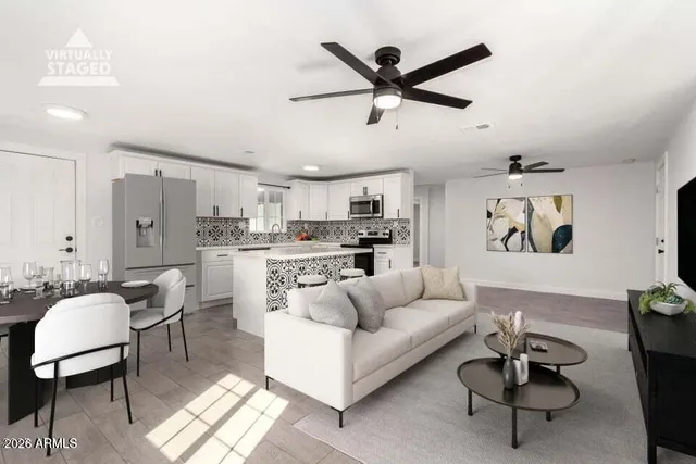 a living room with furniture and a view of kitchen