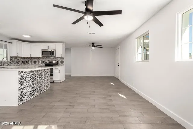 a kitchen with granite countertop a stove cabinets and a sink