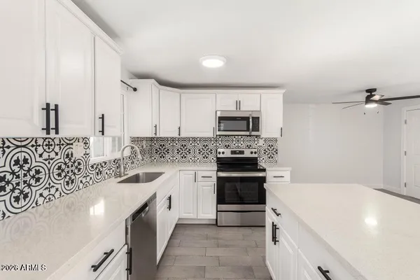 a kitchen with a sink stove and microwave