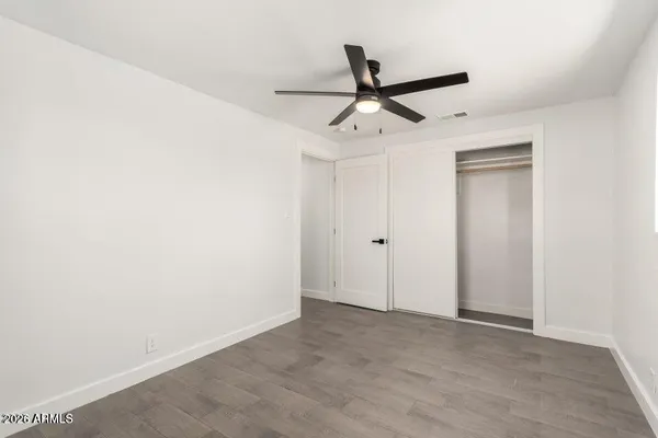 a view of a room with a ceiling fan