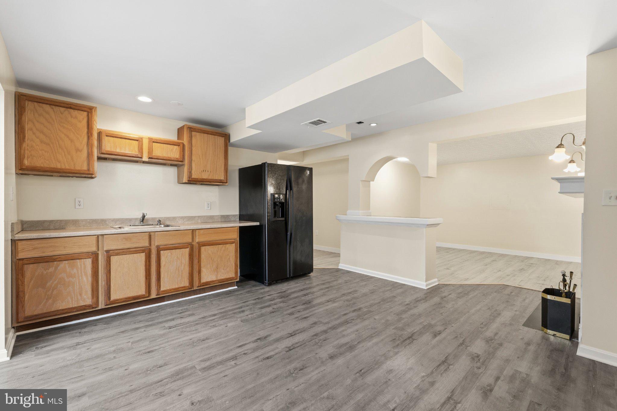 7845 Metacomet Road Hanover, MD 21076 - Photo 14 of 19 a kitchen with granite countertop a refrigerator and a sink