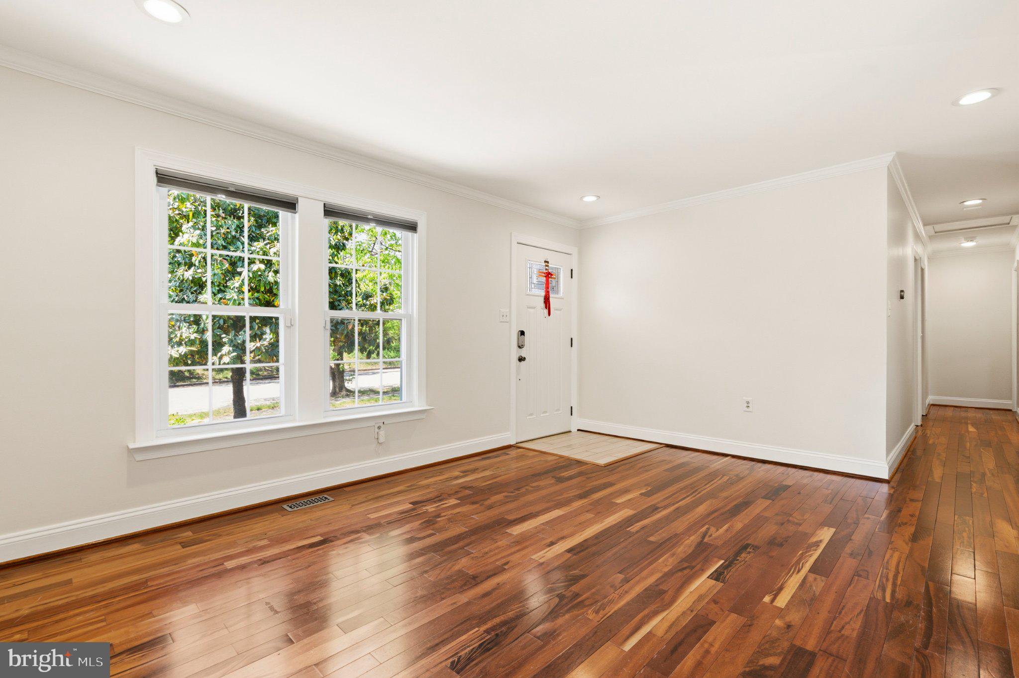 7845 Metacomet Road Hanover, MD 21076 - Photo 2 of 19 an empty room with wooden floor and windows