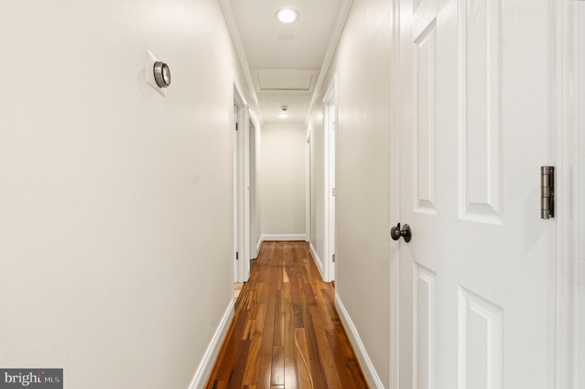 7845 Metacomet Road Hanover, MD 21076 - Photo 4 of 19 a view of a hallway with wooden floor