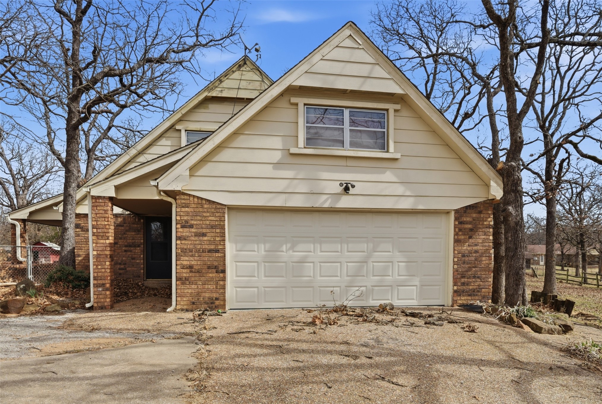 17875 East 589 Road Inola, OK 74036 - Photo 68 of 73 Brick and siding exterior with an attached garage, covered entryway, and gabled roofline