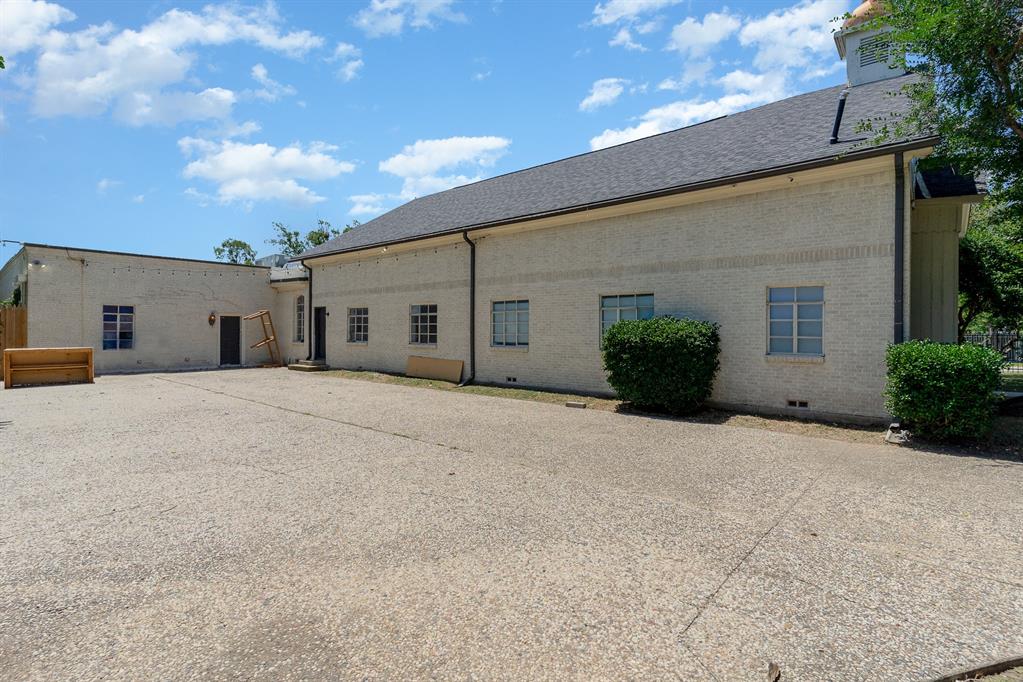 2602 Kings Road, Unit A Dallas, TX 75219 - Photo 12 of 12 Rear view of property with brick siding, crawl space, and roof with shingles