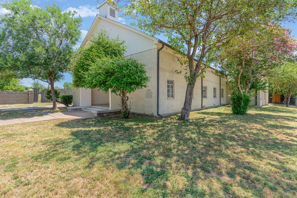 2602 Kings Road, Unit A Dallas, TX 75219 - Photo 3 of 12 View of front facade with brick siding and driveway