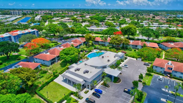 a living room with patio furniture and potted plants
