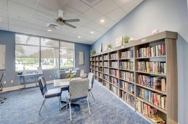 a view of a livingroom with furniture and a bookshelf