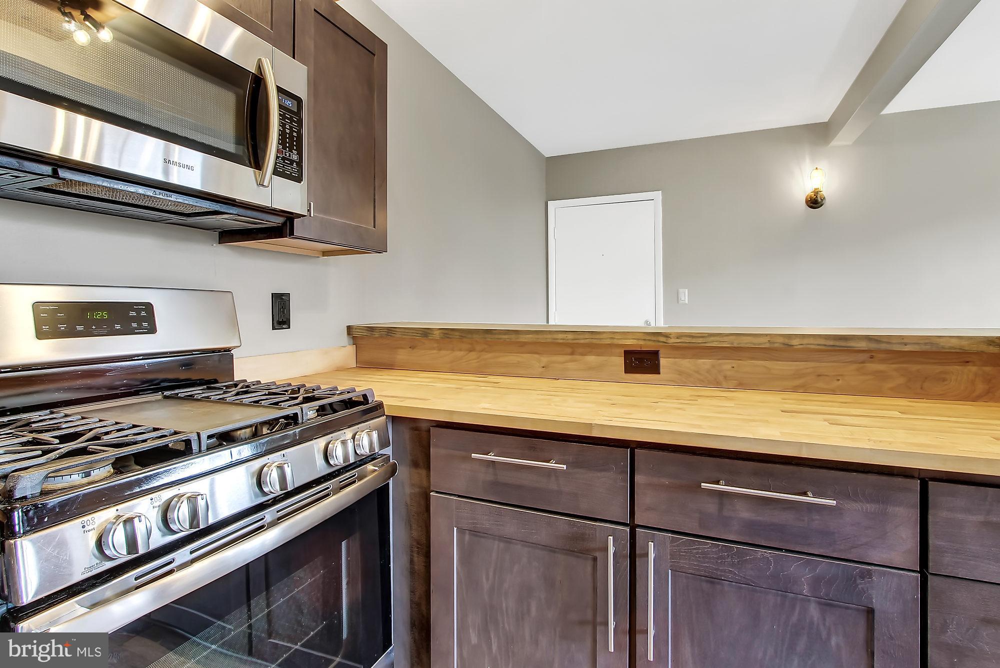 505 Epsom Road, Unit 2D Towson, MD 21286 - Photo 17 of 23 Self-cleaning 5 burner gas range w/griddle.