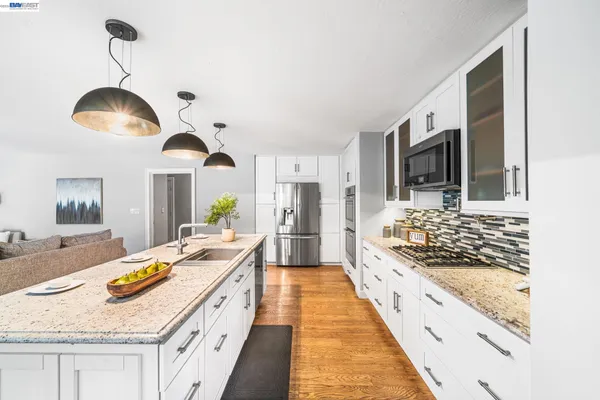 a view of deck with furniture and barbeque oven in the backyard