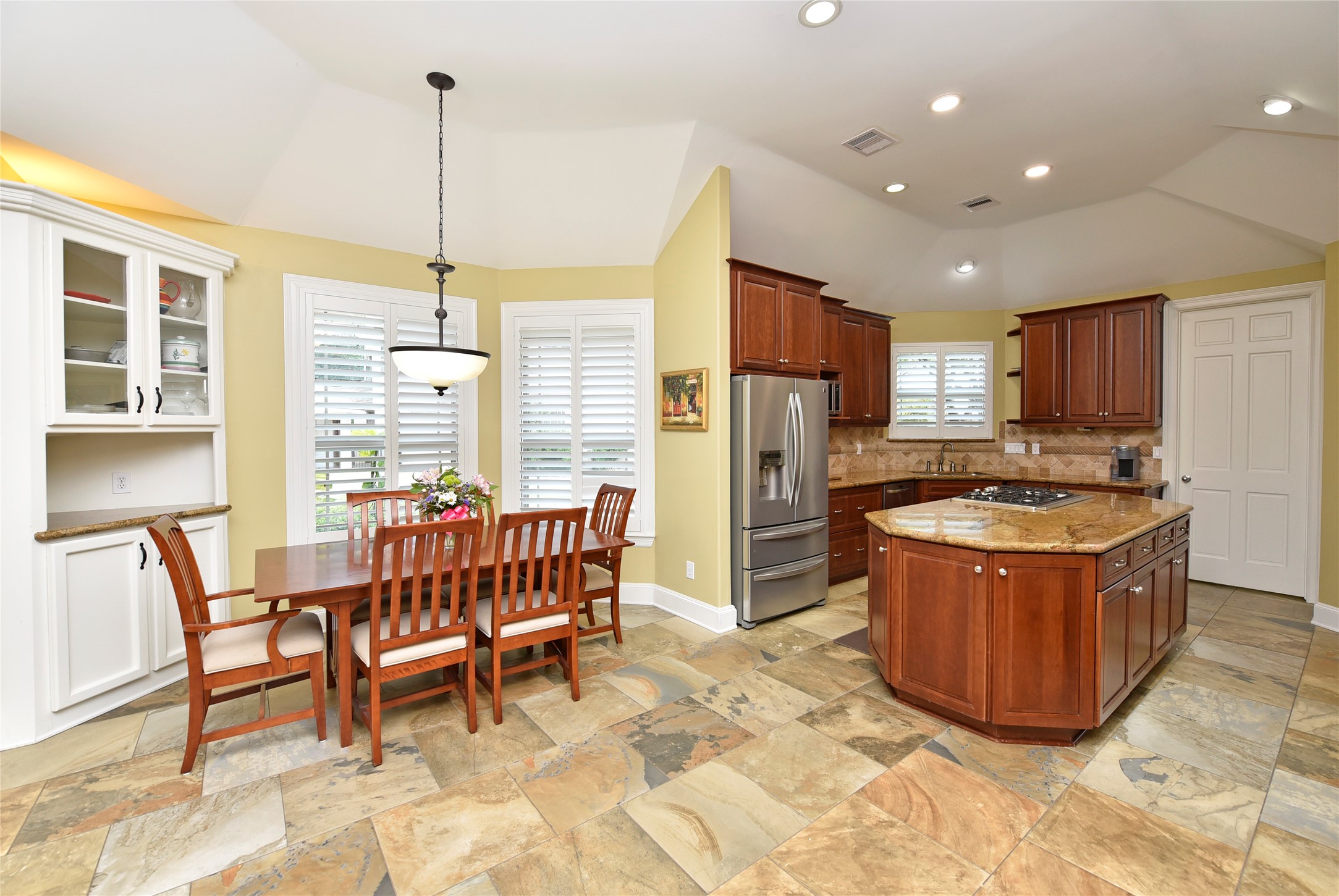 3315 Meadowside Drive Sugar Land, TX 77478 - Photo 13 of 48 a kitchen with stainless steel appliances granite countertop a table chairs and a refrigerator
