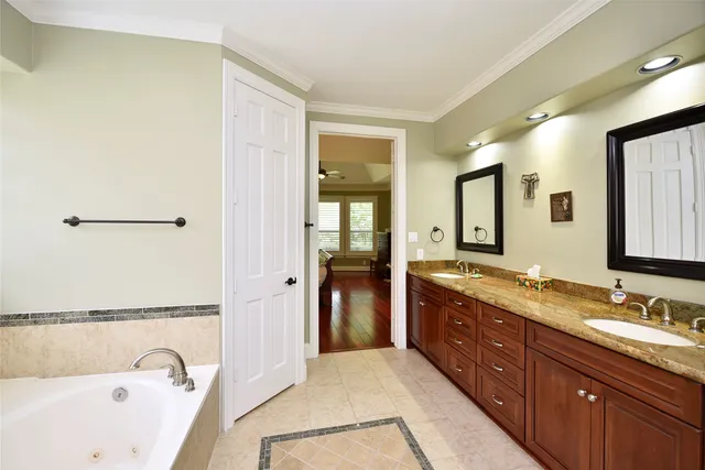a spacious bathroom with a granite countertop tub sink and mirror