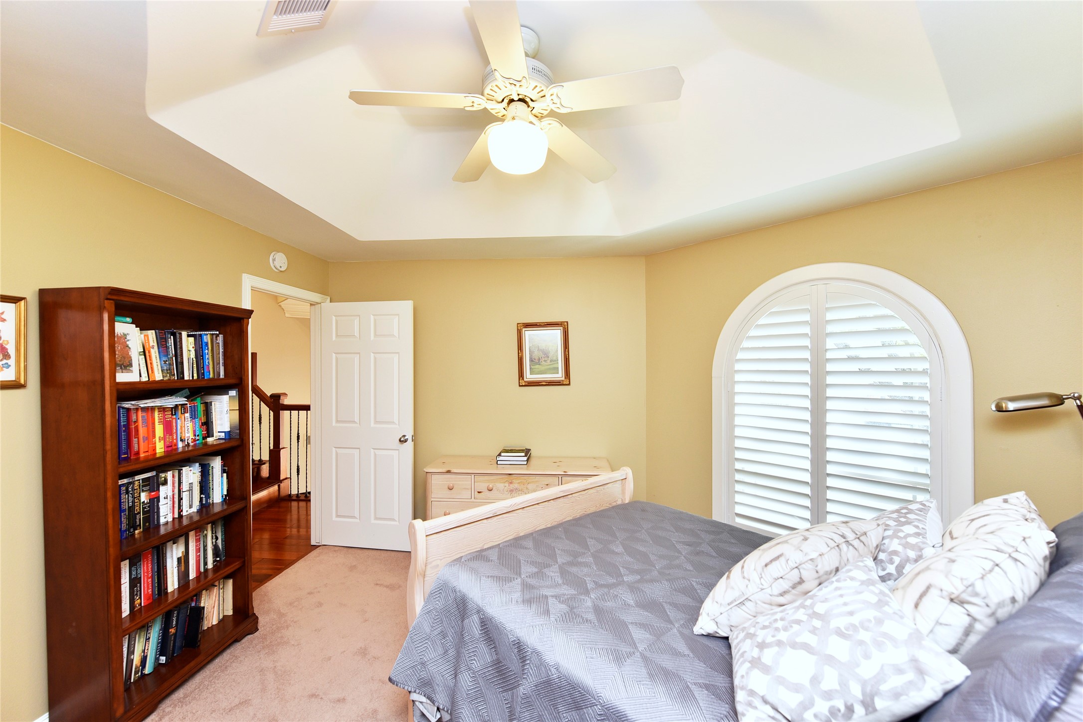 3315 Meadowside Drive Sugar Land, TX 77478 - Photo 33 of 48 a bedroom with a bed cabinets and a book shelf