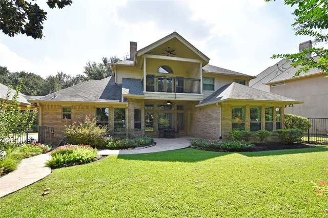 a view of a garden with plants and large trees