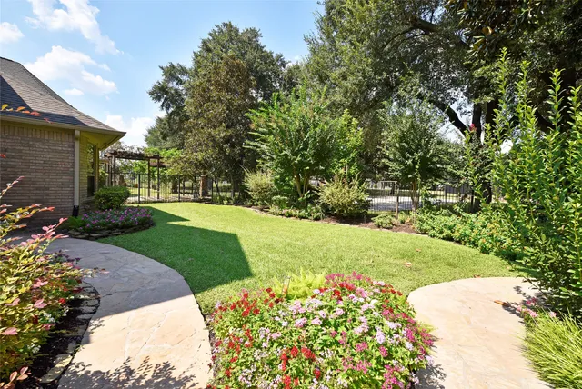 a view of a swimming pool with lawn chairs under an umbrella