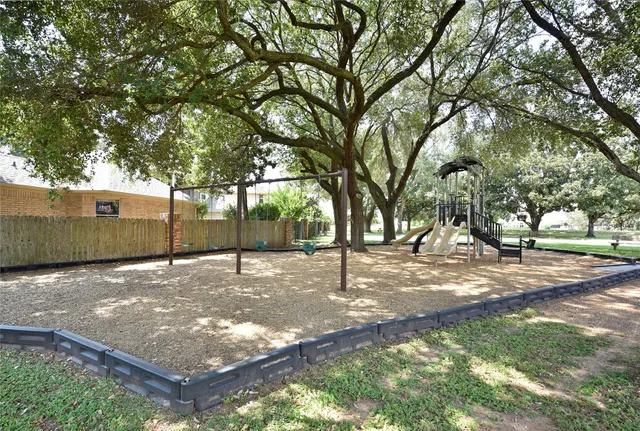 a view of a playground with a tree