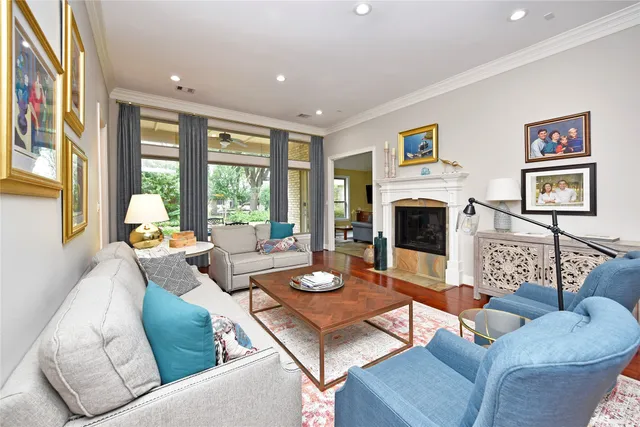 a living room with furniture fireplace and a large window