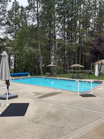 a view of a swimming pool with sitting area