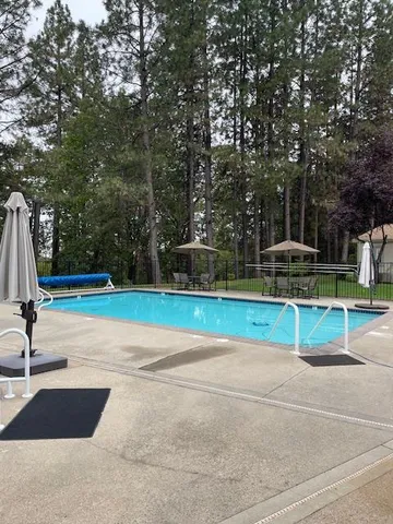 a view of a swimming pool with sitting area