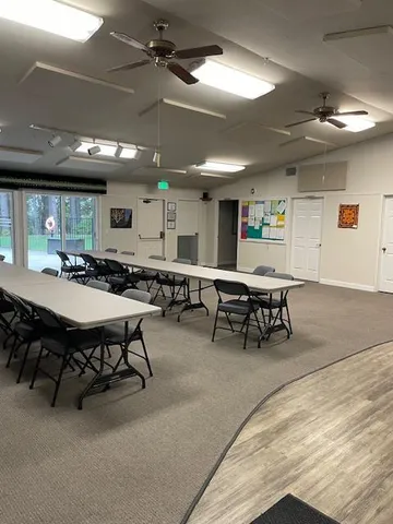 a kitchen with a dining table chairs and a sink