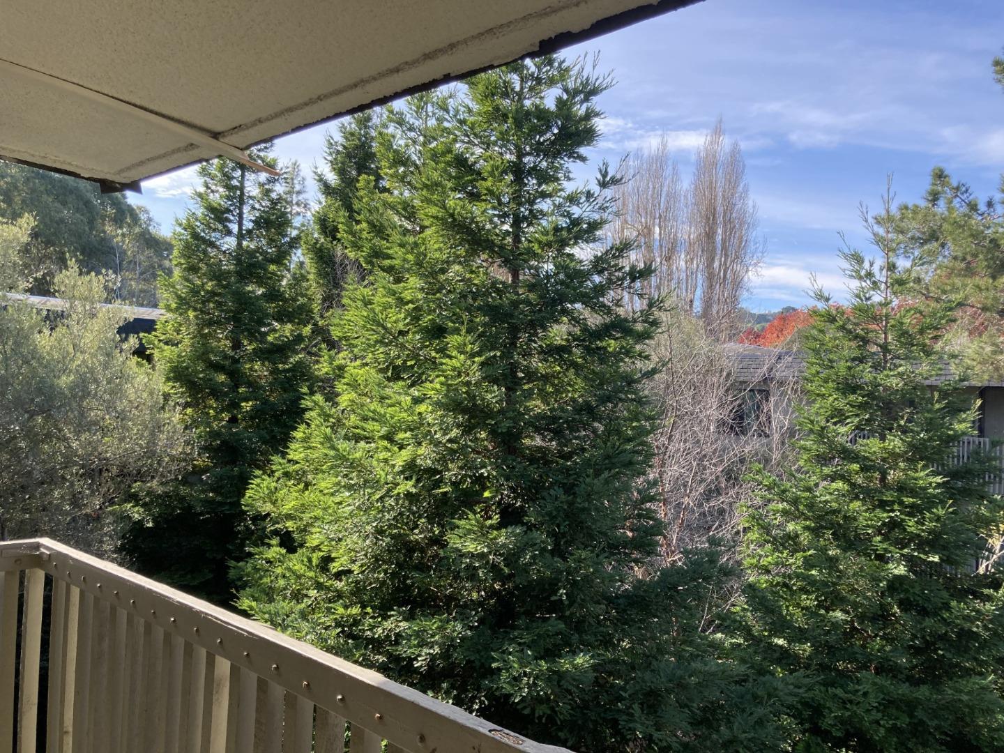 a balcony with trees in front of it