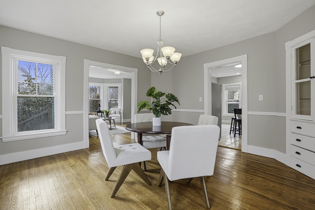 2 Maple Avenue Natick, MA 01760 - Photo 11 of 41 a dining room with wooden floor a chandelier a glass table and chairs
