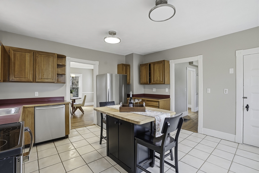 2 Maple Avenue Natick, MA 01760 - Photo 15 of 41 a kitchen with a table chairs and a refrigerator