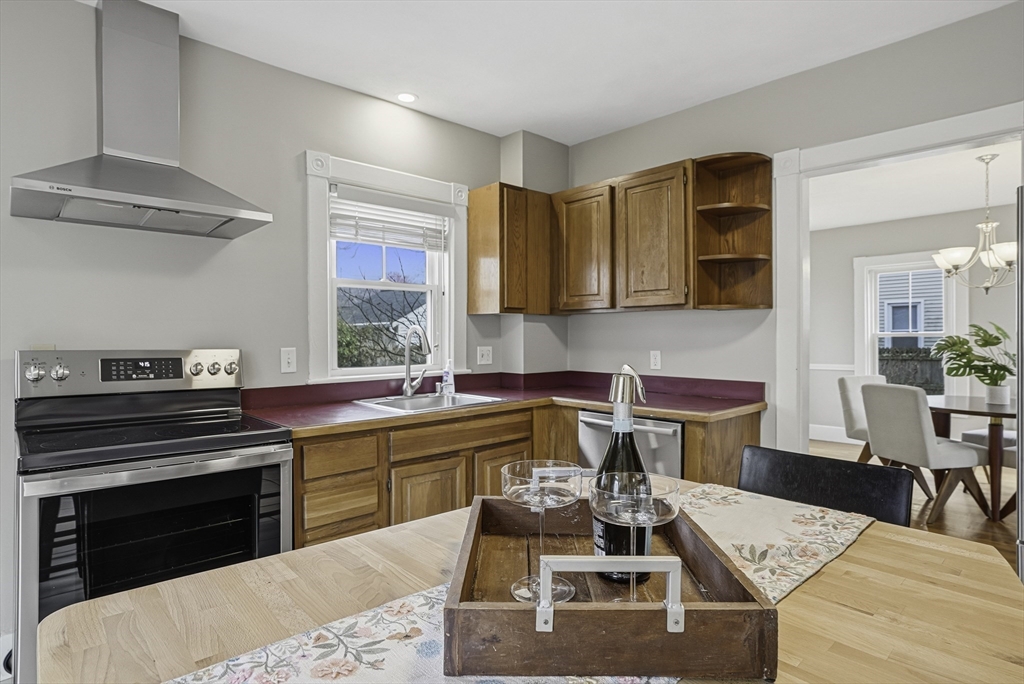 2 Maple Avenue Natick, MA 01760 - Photo 17 of 41 a kitchen with a table chairs stove and cabinets