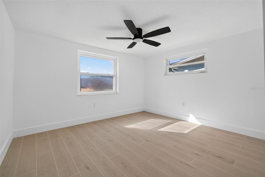 12734 2nd Isle Hudson, FL 34667 - Photo 13 of 22 an empty room with a window and a ceiling fan