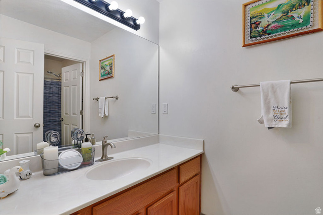 464 West Saddle Back Drive Springville, UT 84663 - Photo 6 of 15 Bathroom vanity with a rectangular undermount sink, brushed nickel faucet, and a large wall-mounted mirror