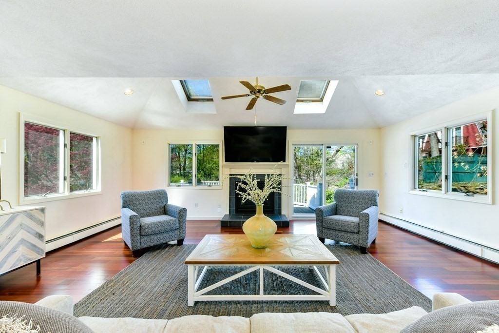 47 White Pine Road Newton, MA 02464 - Photo 7 of 24 a living room with furniture a flat screen tv and a large window