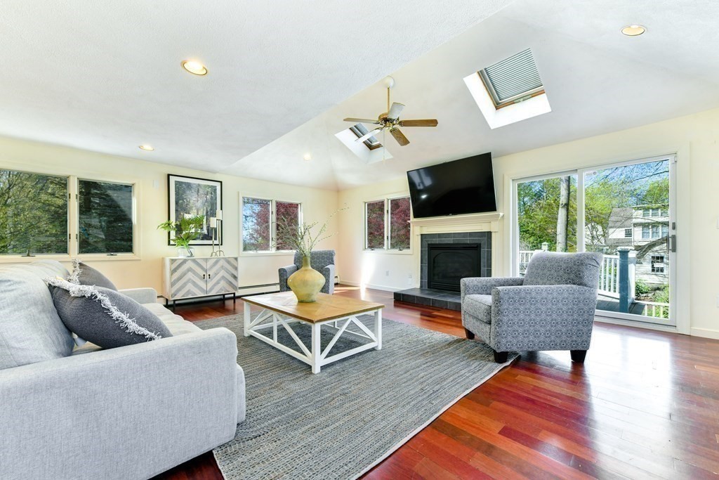 47 White Pine Road Newton, MA 02464 - Photo 9 of 24 a living room with furniture a flat screen tv and a fireplace